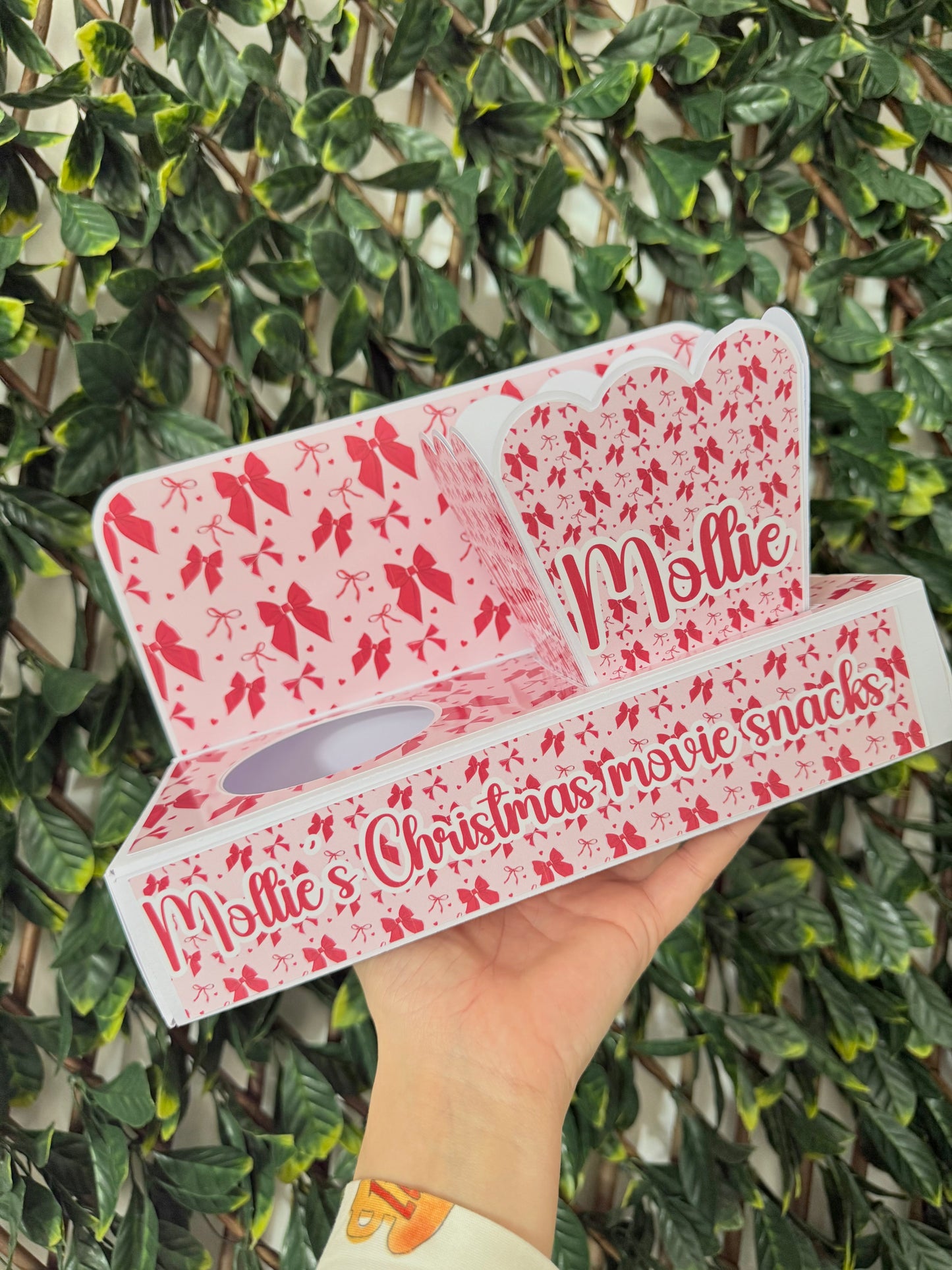 Festive pink and red bow Christmas movie snack tray with popcorn holder