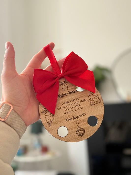 Elf decorating the tree bauble